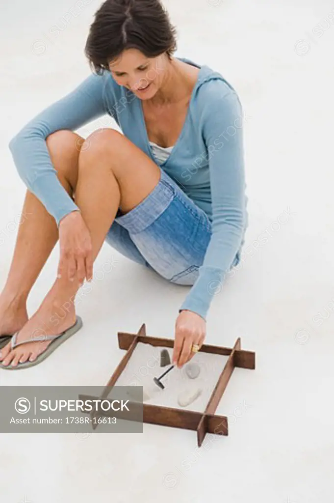 Woman playing with a sandbox