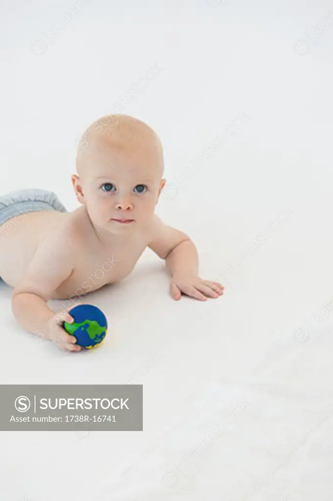 Baby boy holding a ball