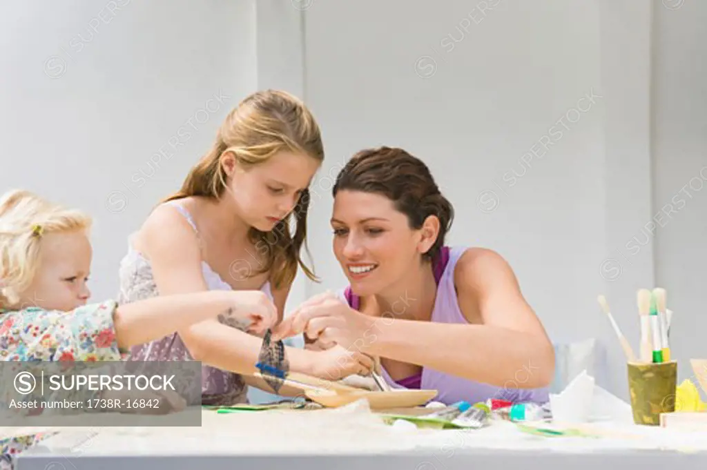 Woman teaching her two daughters