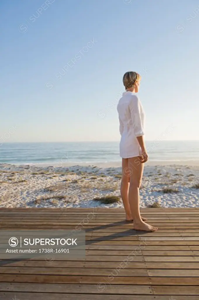 Woman standing on a boardwalk