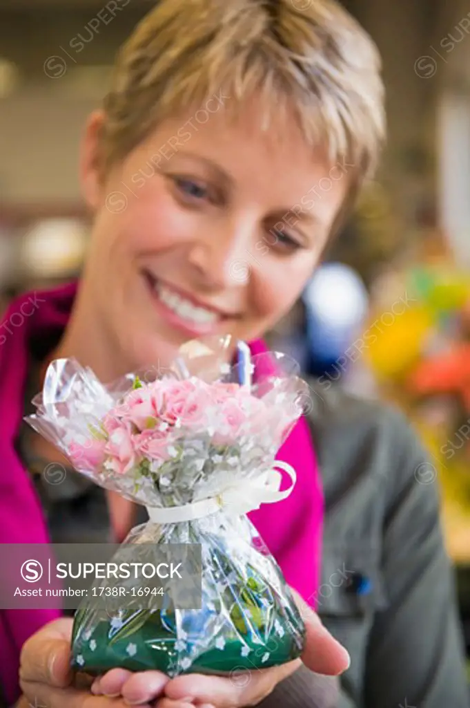 Woman holding a bouquet of flowers and smiling