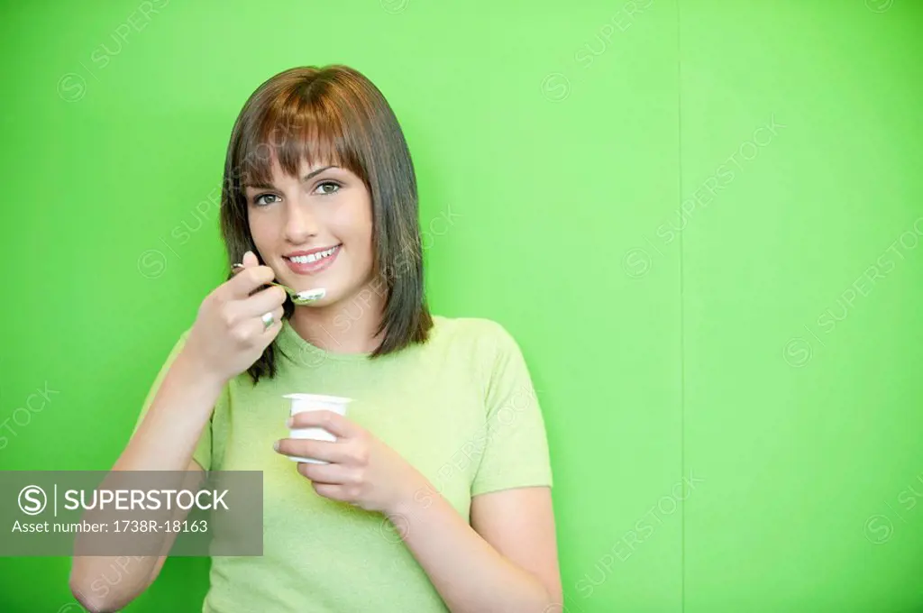 Portrait of a woman eating yogurt