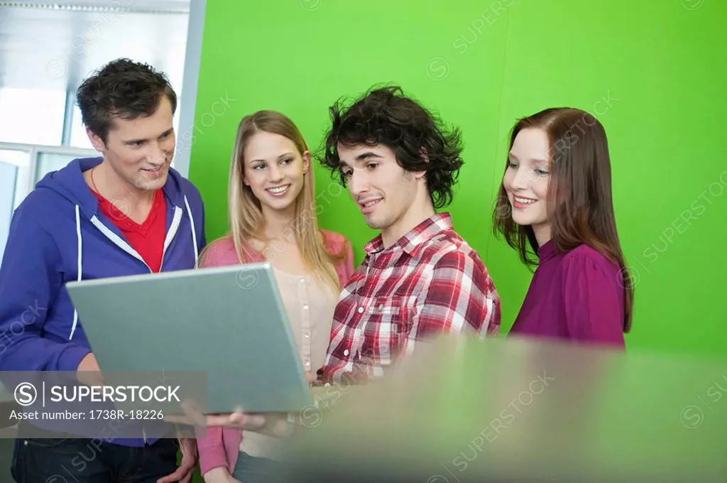 Businessman using a laptop with his colleagues in an office