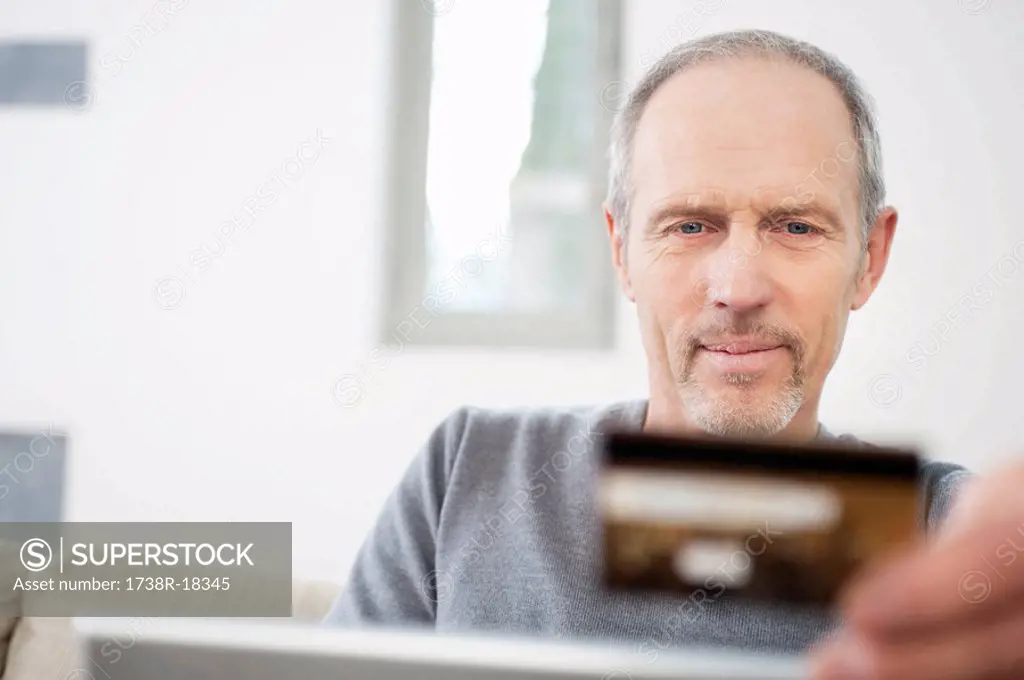 Man doing online shopping with a laptop