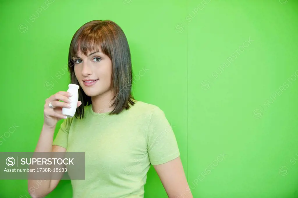 Portrait of a woman drinking probiotic drink