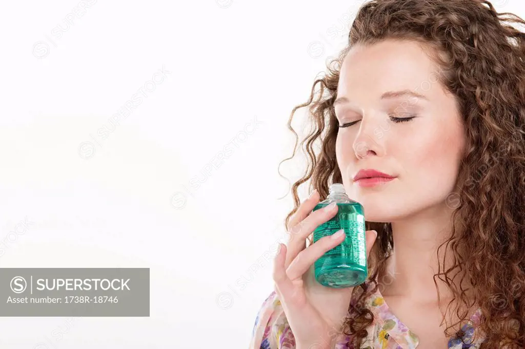 Woman smelling aromatherapy oil