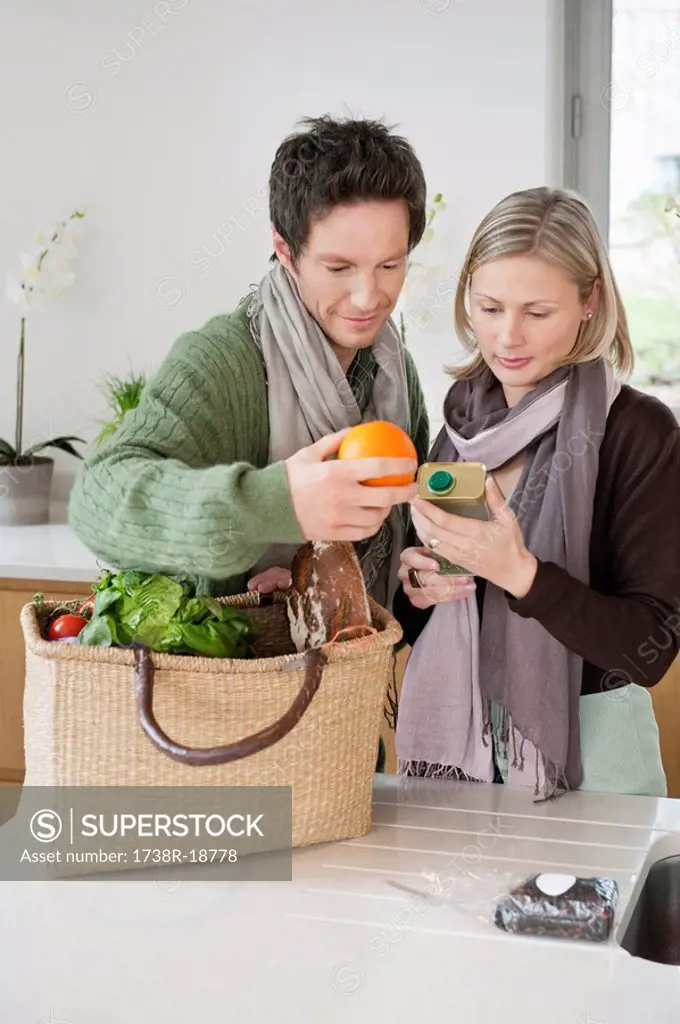 Couple checking groceries at home