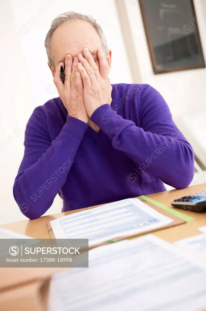 Man looking worried while filling his tax form