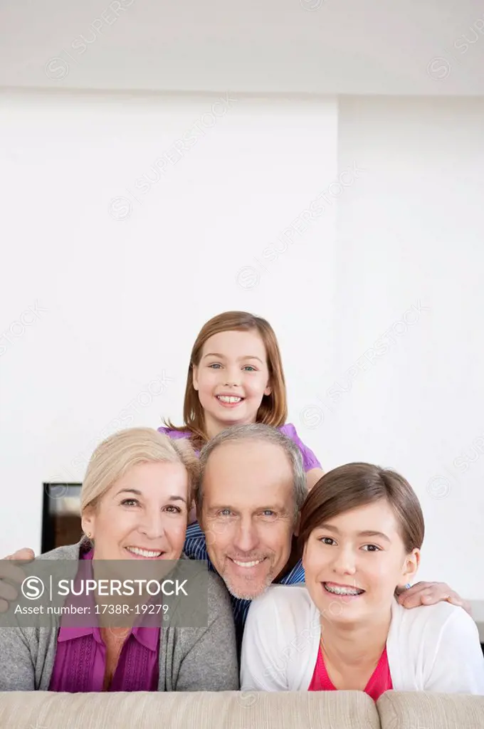 Couple smiling with their granddaughters