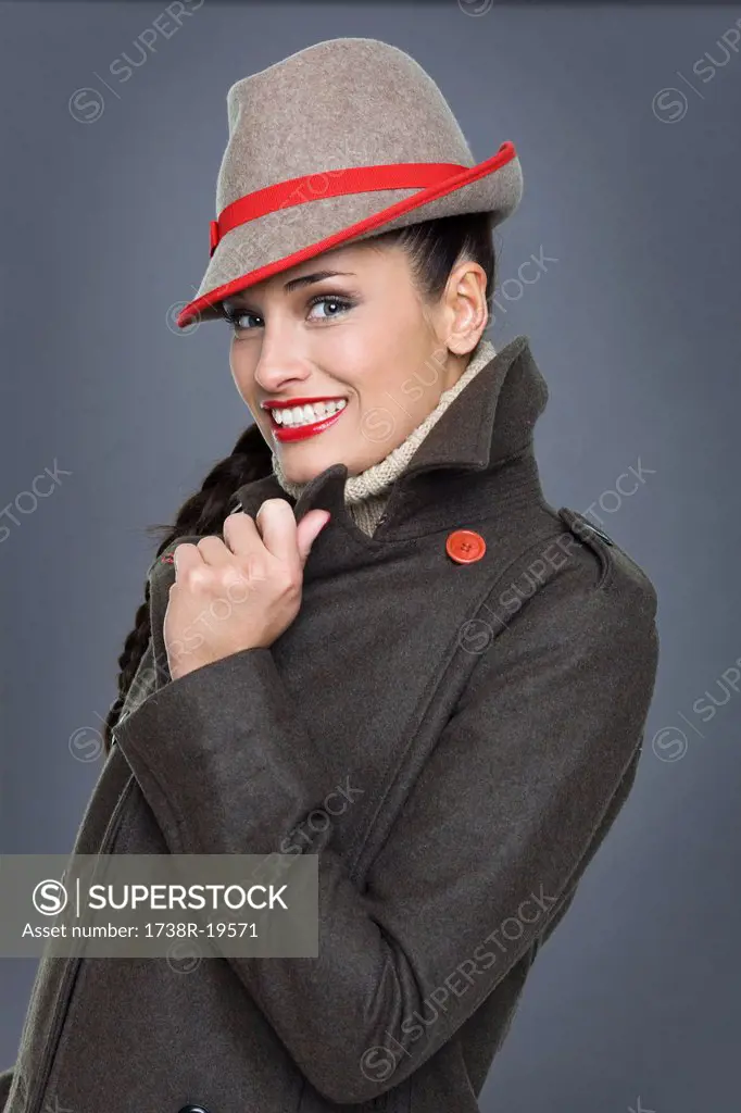 Young woman wearing jacket and fedora