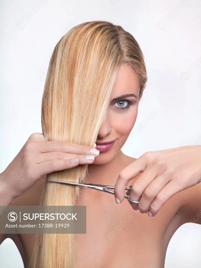 Young woman cutting hair