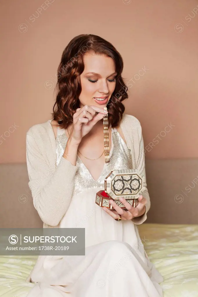Young woman opening jewelry box