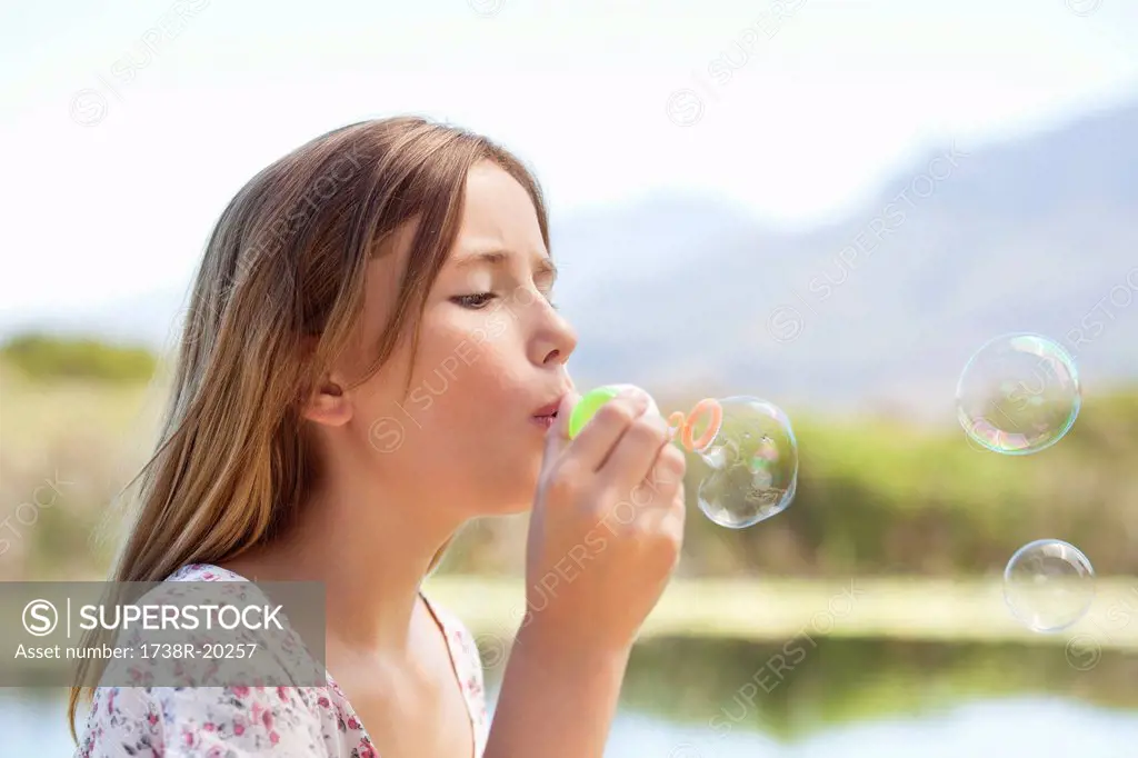 Close_up of a girl blowing bubbles