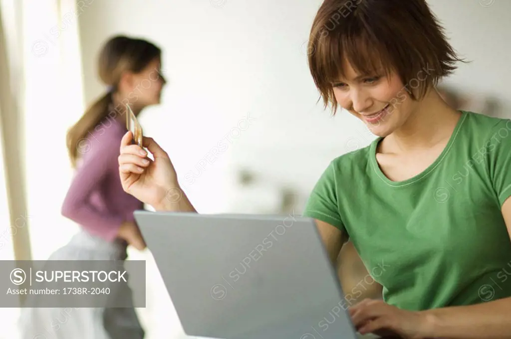 Woman with computer, girl in background