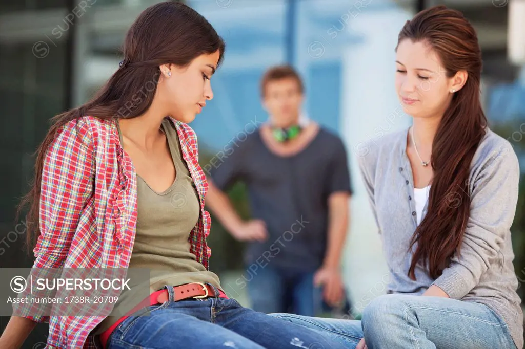 Two female friends sitting in a campus