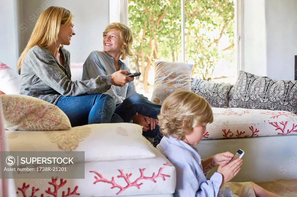 Children and mother using electronic gadgets at home