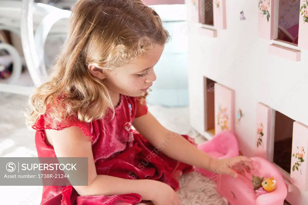 Cute little girl playing with dolls