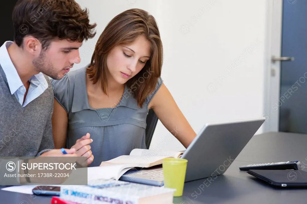 University students using laptop in classroom