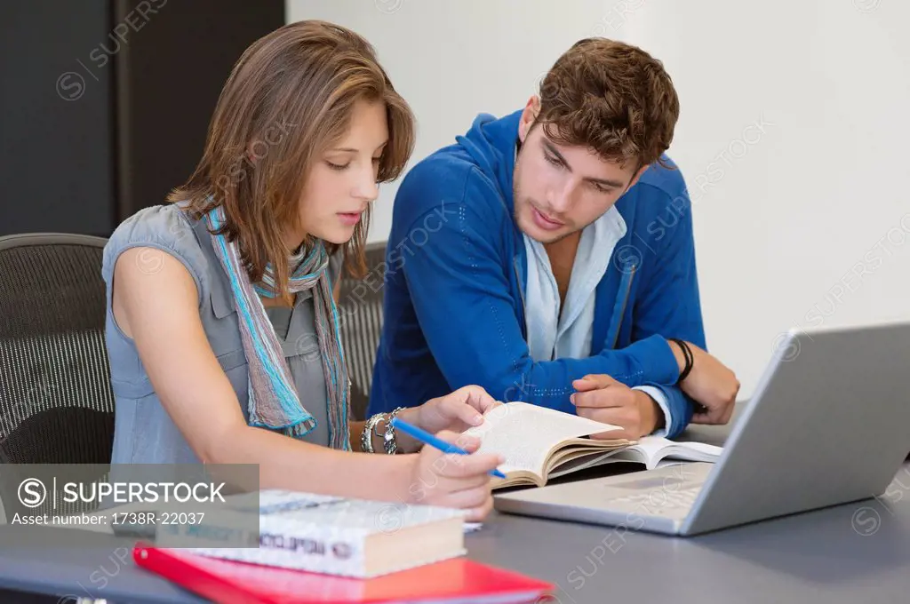 University students using laptop in classroom