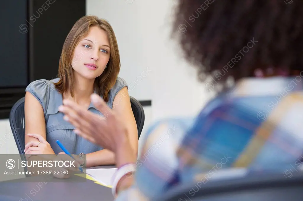 Businesswoman taking an interview of an African American woman