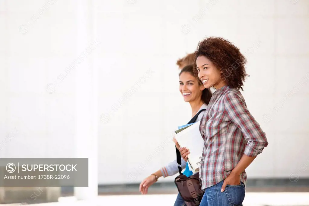 Two female friends walking in campus
