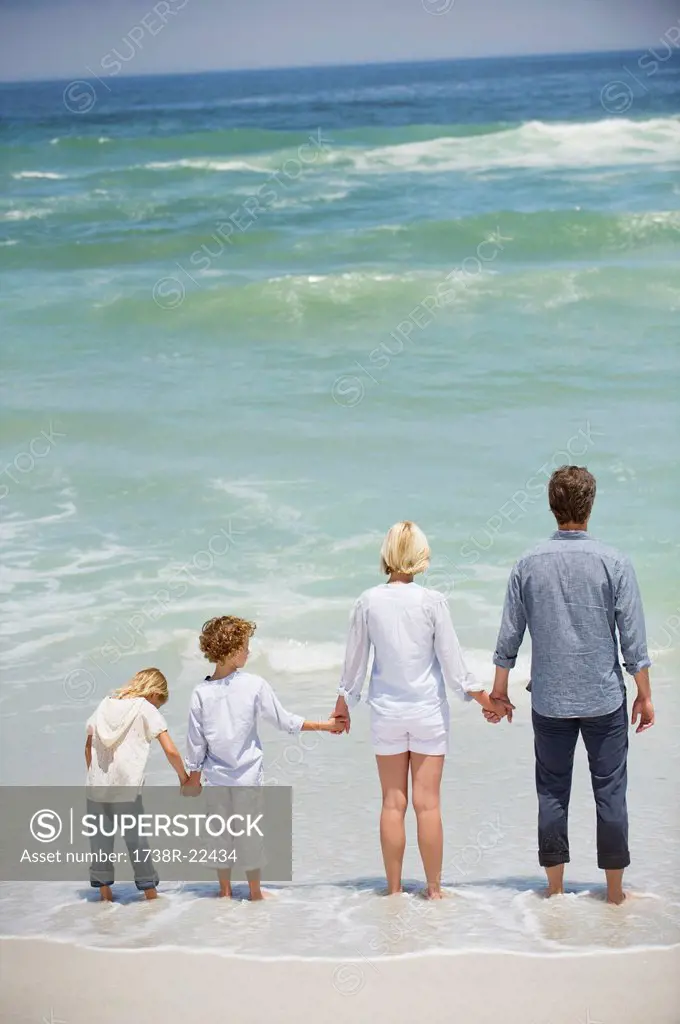 Family with two children standing on the beach