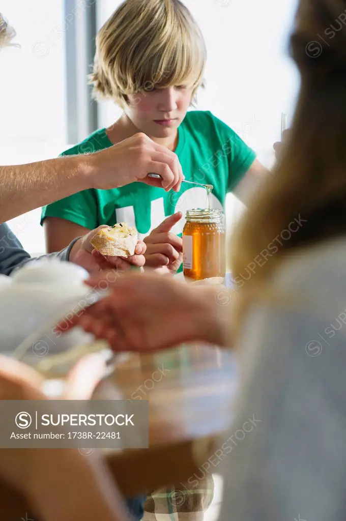 Teenage boy having breakfast with his parents