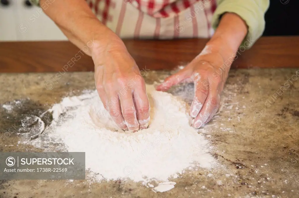 Close_up of a senior woman´s hand mixing flour