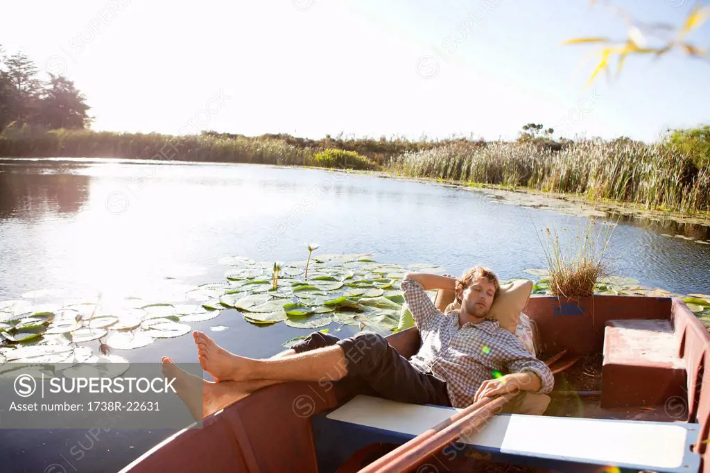 Young man sleeping in the boat