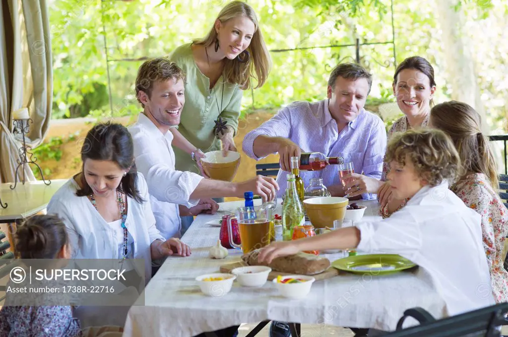Multi generation family eating food at house