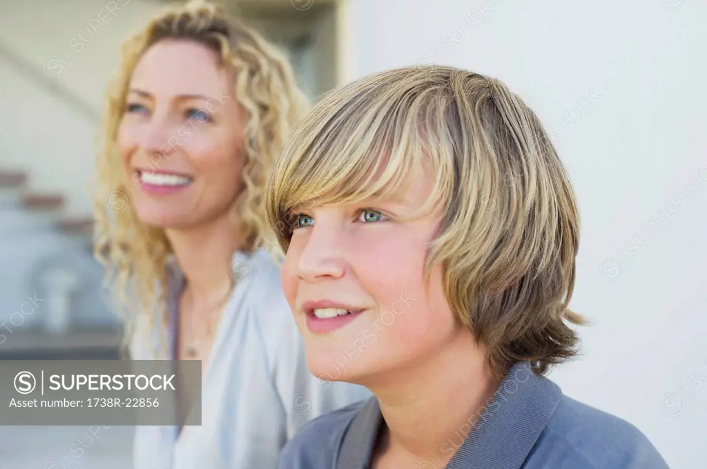Close_up of a teenage boy smiling with his mother