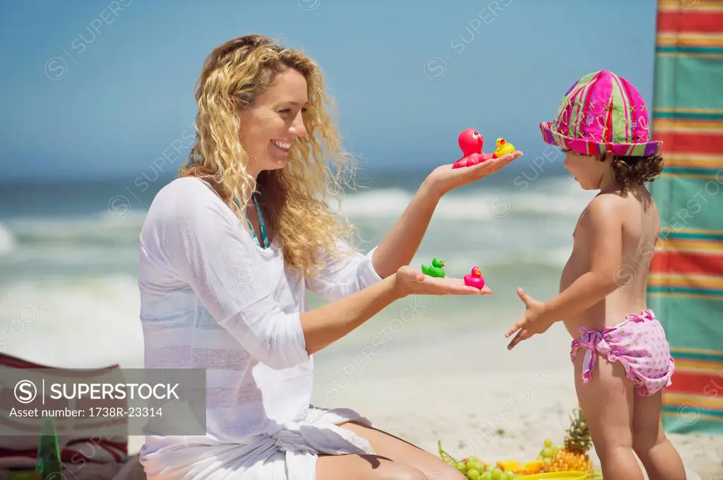 Woman giving toys to her daughter