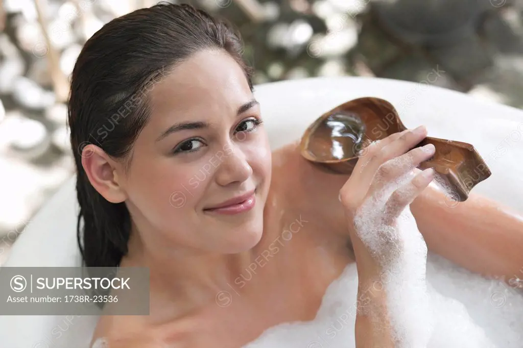 Portrait of a beautiful young woman taking bubble bath