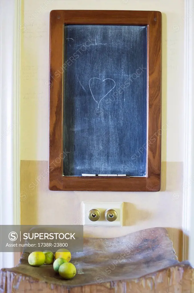 Details of blackboard with fruits kept on wooden stand