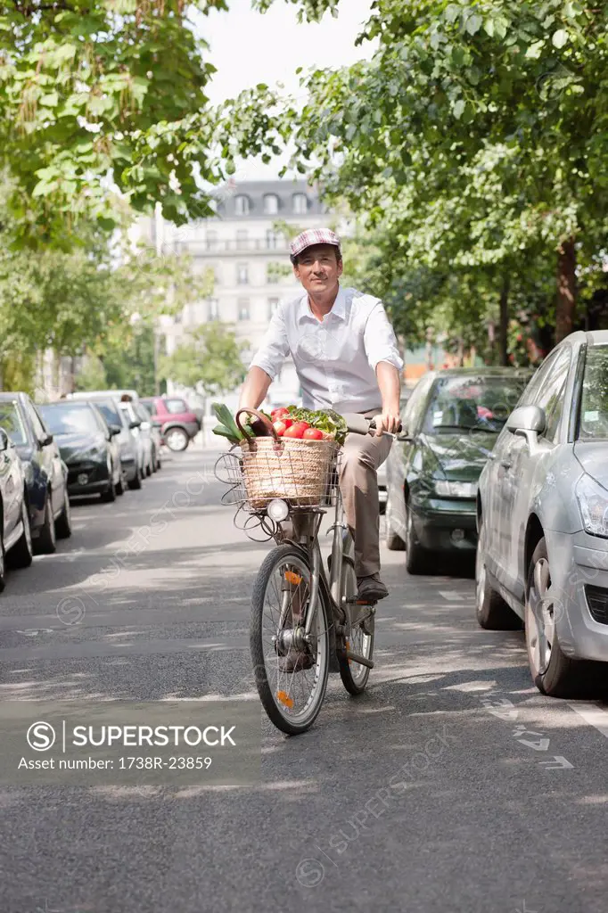 Man carrying vegetables on a bicycle, Paris, Ile_de_France, France
