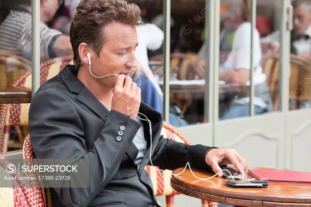 Man talking on a mobile phone in a restaurant, Paris, Ile_de_France, France