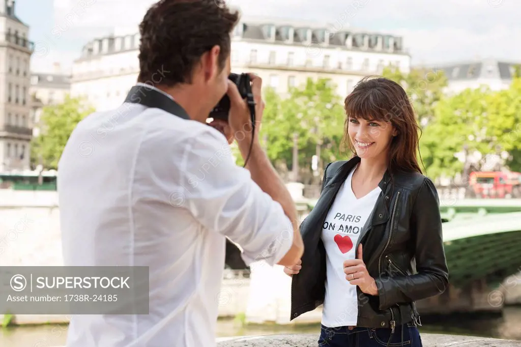 Man taking a picture of a woman with a camera, Seine River, Paris, Ile_de_France, France