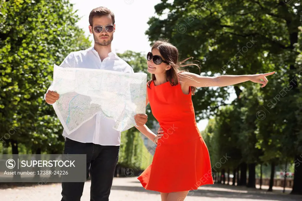 Man reading a map with a woman pointing, Terrasse De l´Orangerie, Jardin des Tuileries, Paris, Ile_de_France, France