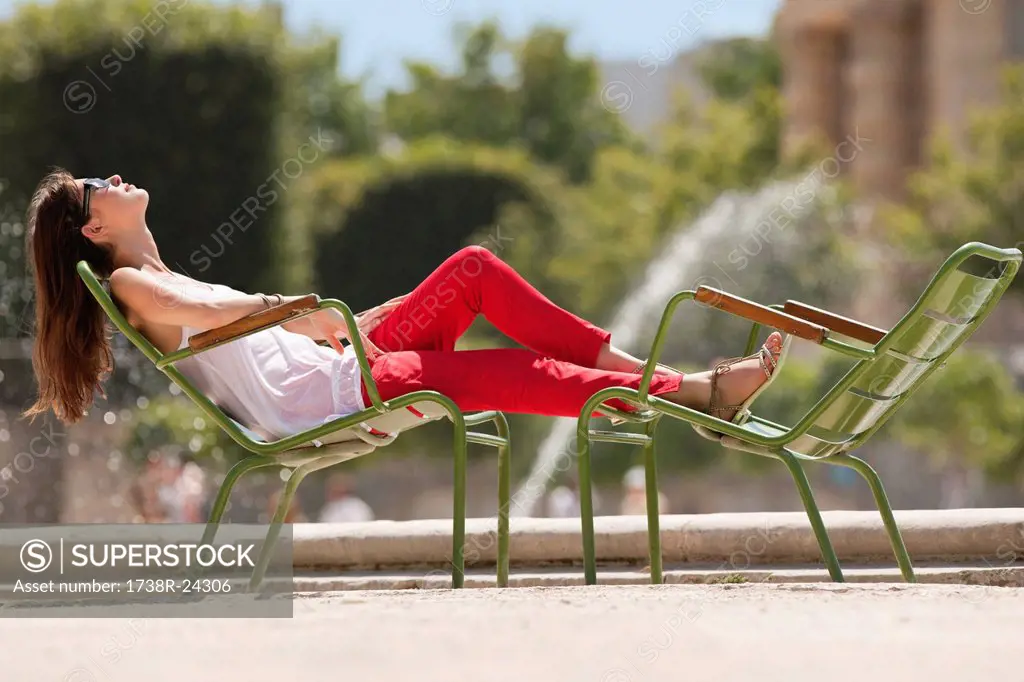 Woman resting in a chair near a pond, Bassin octogonal, Jardin des Tuileries, Paris, Ile_de_France, France