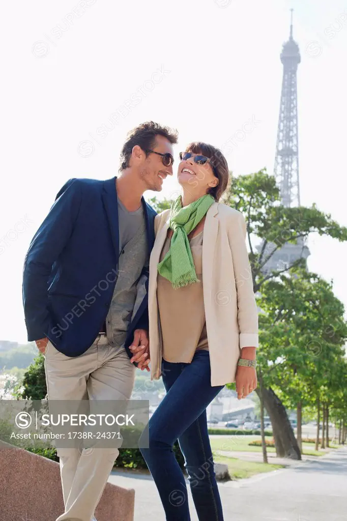Couple moving up steps with the Eiffel Tower in the background, Paris, Ile_de_France, France