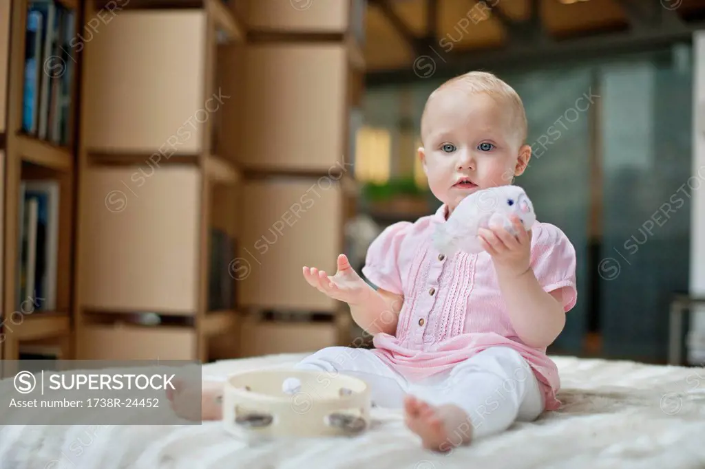 Baby girl playing with a toy