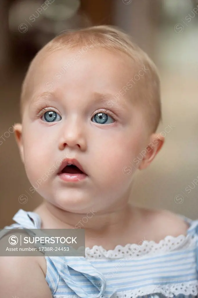 Close_up of a baby girl looking away