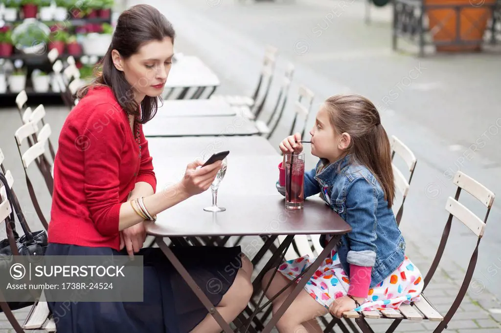 Woman with her daughter sitting in a cafe