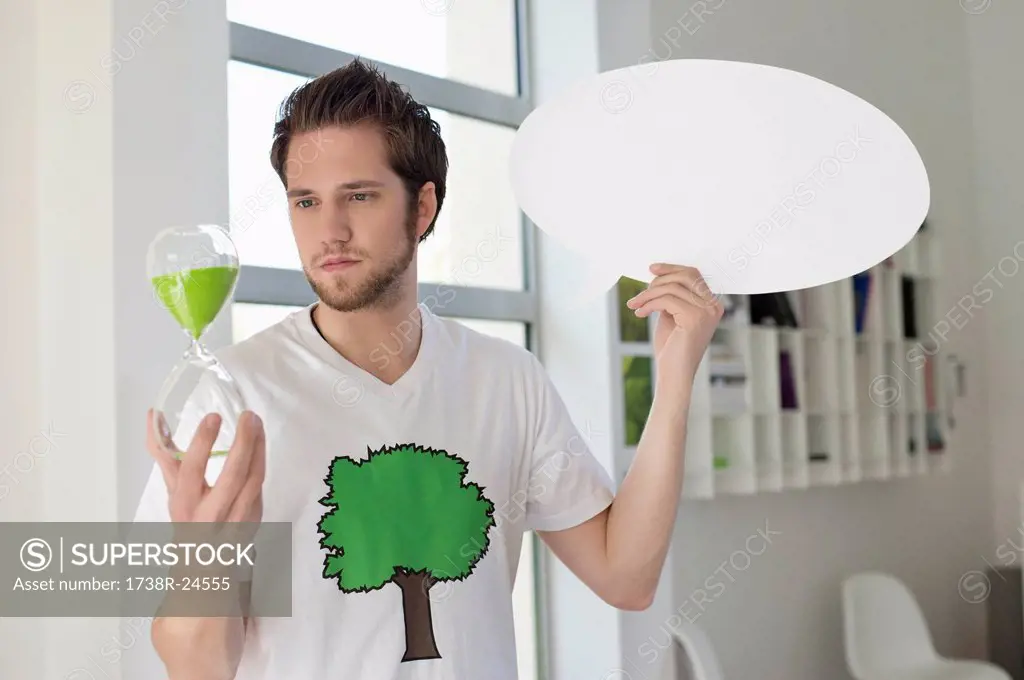 Man holding an hour glass and a speech bubble