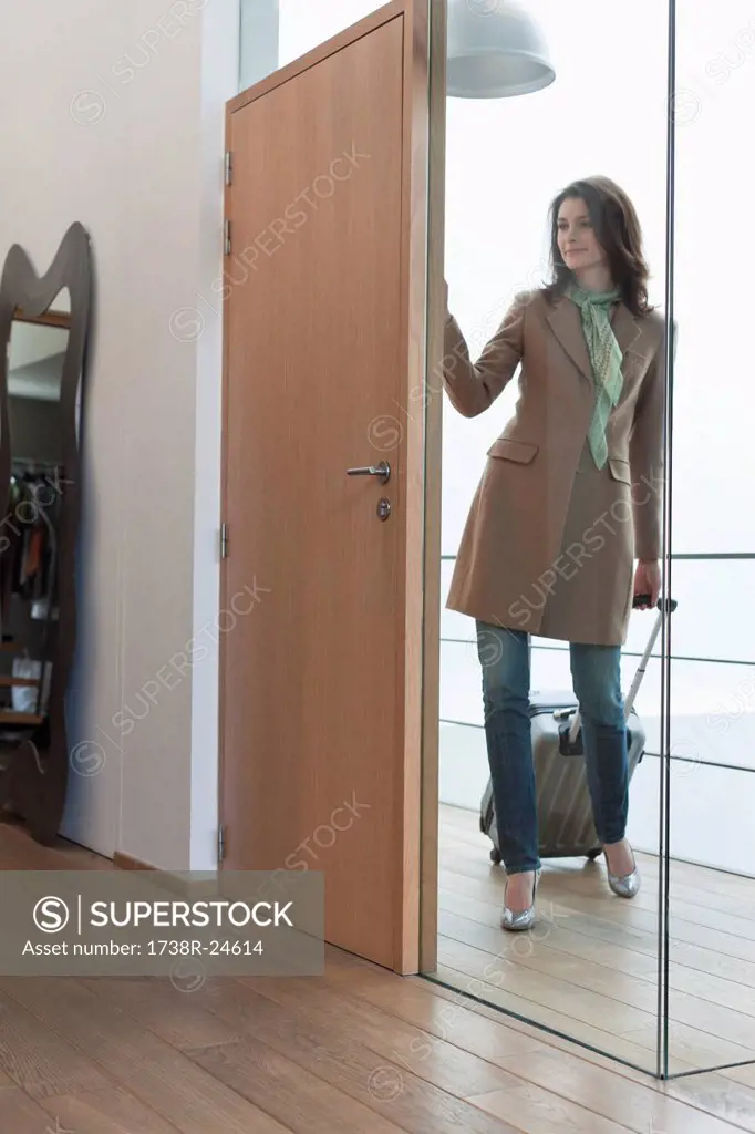 Woman arriving at home from vacations