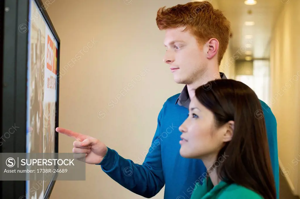 Business people looking at display screen