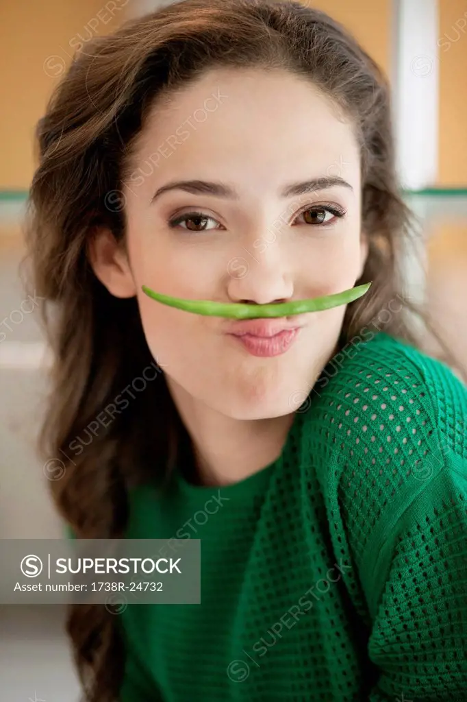 Woman making fun with a French bean
