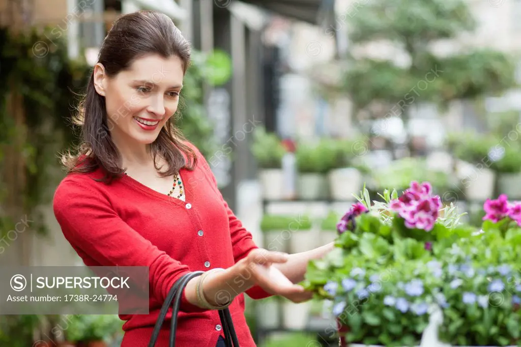 Close_up of a woman looking at flowers in a flower shop