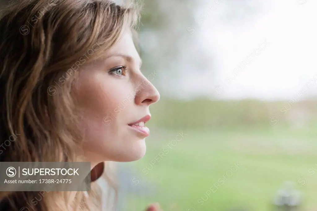 Close_up of a woman looking through window