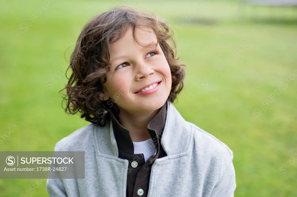 Close_up of a boy smiling in a field